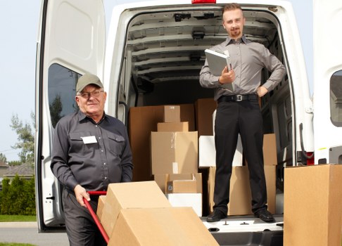 Professional removals team packing furniture in Elmstead