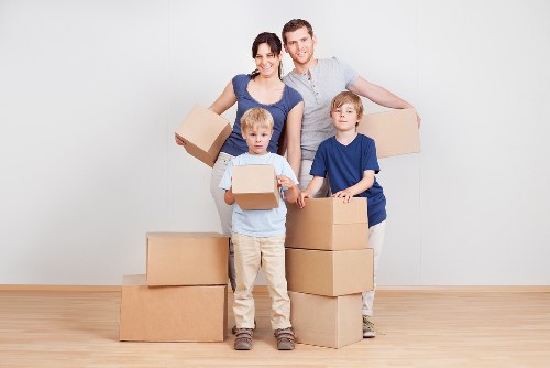 Experienced movers unloading items at a new home in Woodford